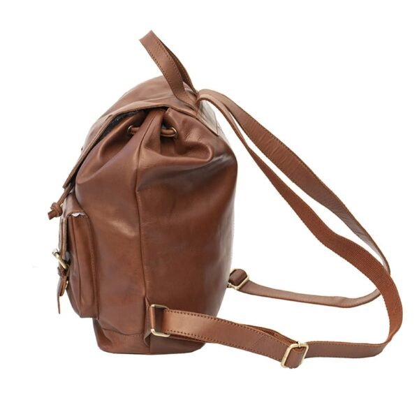 side view of a brown leather backpack. The backpack is large in side with adjustable leather shoulder straps.