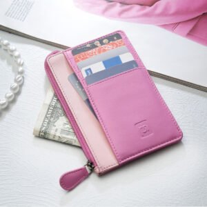 A pink leather card holder wallet with a zippered compartment is displayed open, showing multiple credit cards and cash neatly stored inside.