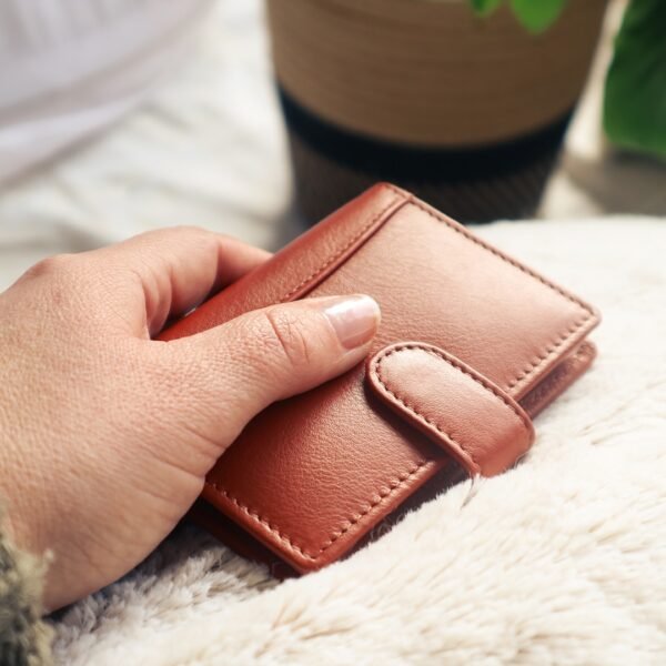 a woman has a luxury leather wallet in her hand