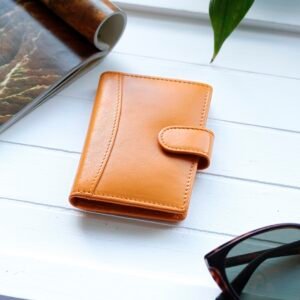 a stylish handcrafted yellow credit card holder is sitting on a white wood table