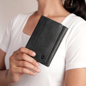 A person holding the black trifold wallet, demonstrating its compact size and easy portability, perfect for everyday use.