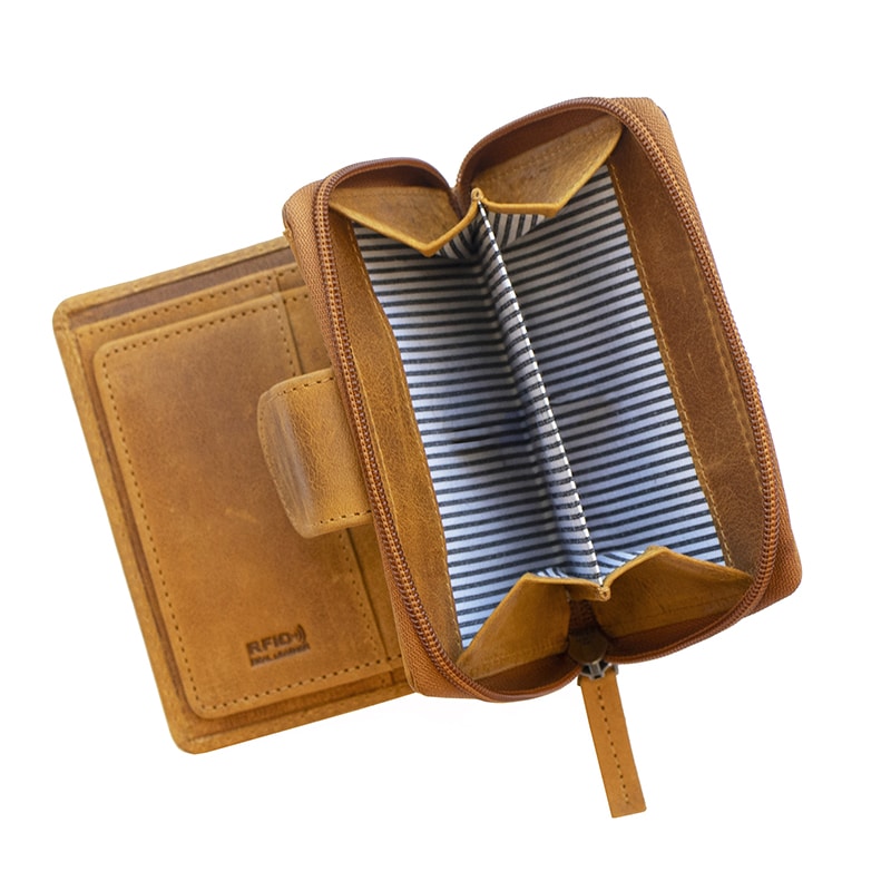 a leather purse is open to show a zipped coin pocket. The coin pocket is lined in blue and white striped fabric and it has a middle divider.