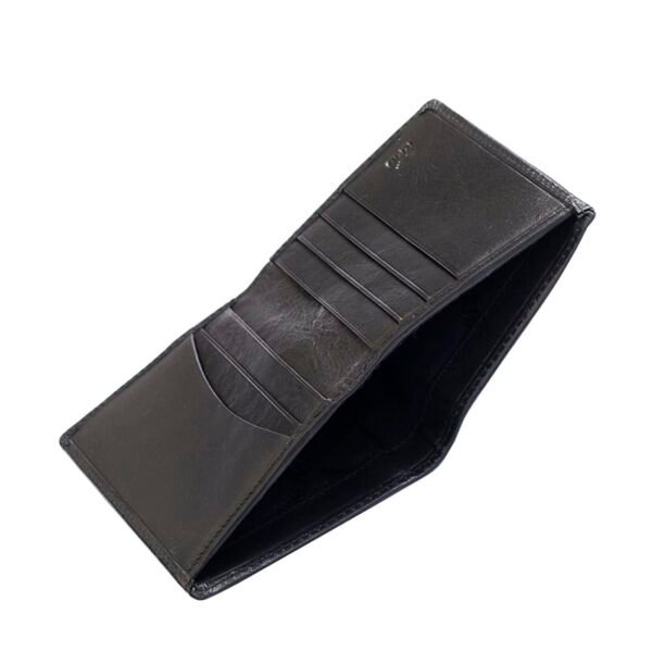 a black leather wallet is open to show a slip pocket for cash