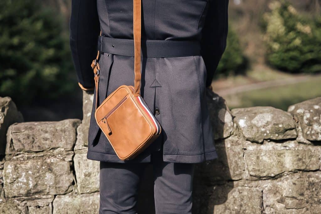  Man with a brown leather crossbody bag. PRIMEHIDE Leather Texan Collection