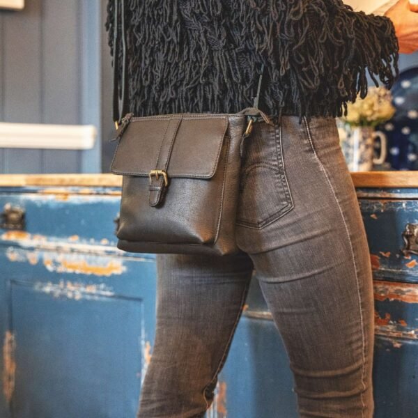 A smart casual woman with a black crossbody bag