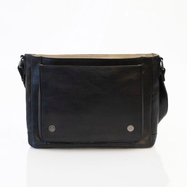 black leather messenger bag is open to show a front slip pocket and a magnetic button closure for the top flap.